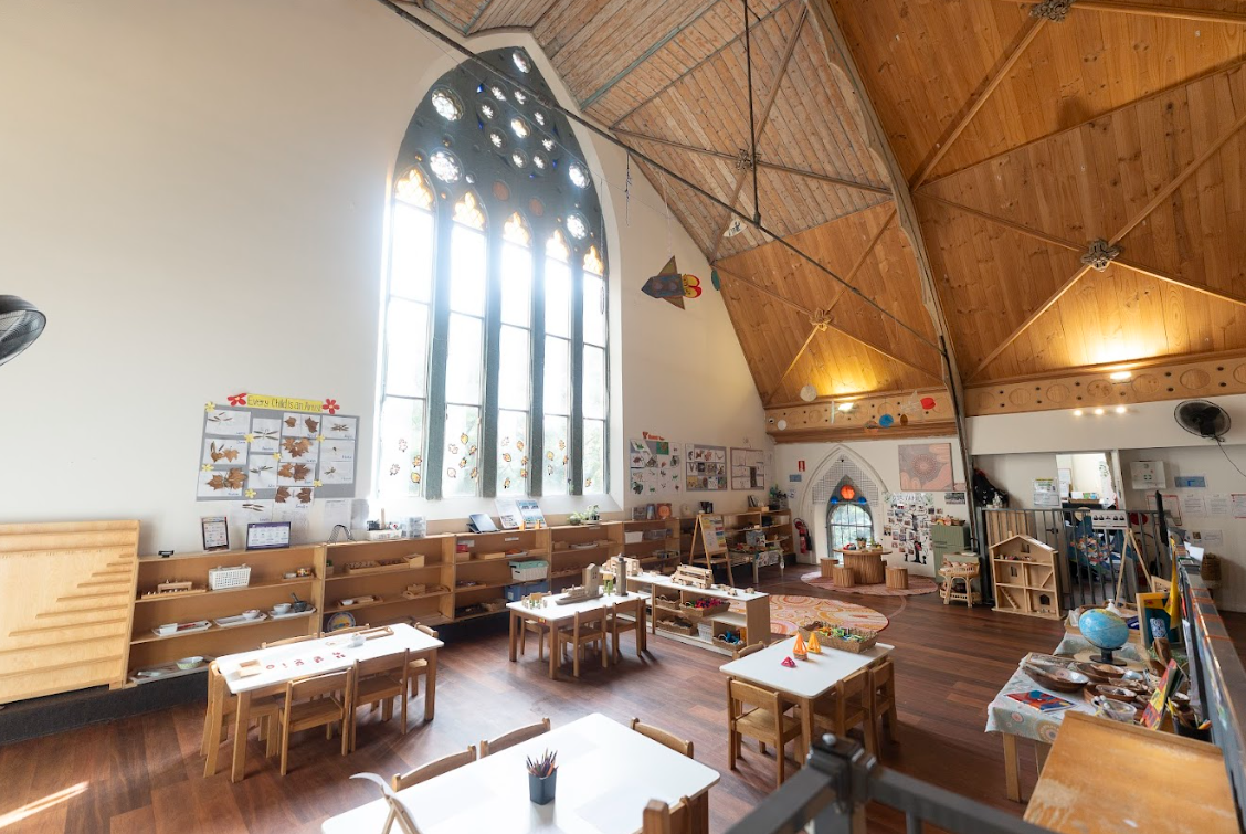 WeKidz classroom with stained glass windows and timber ceiling