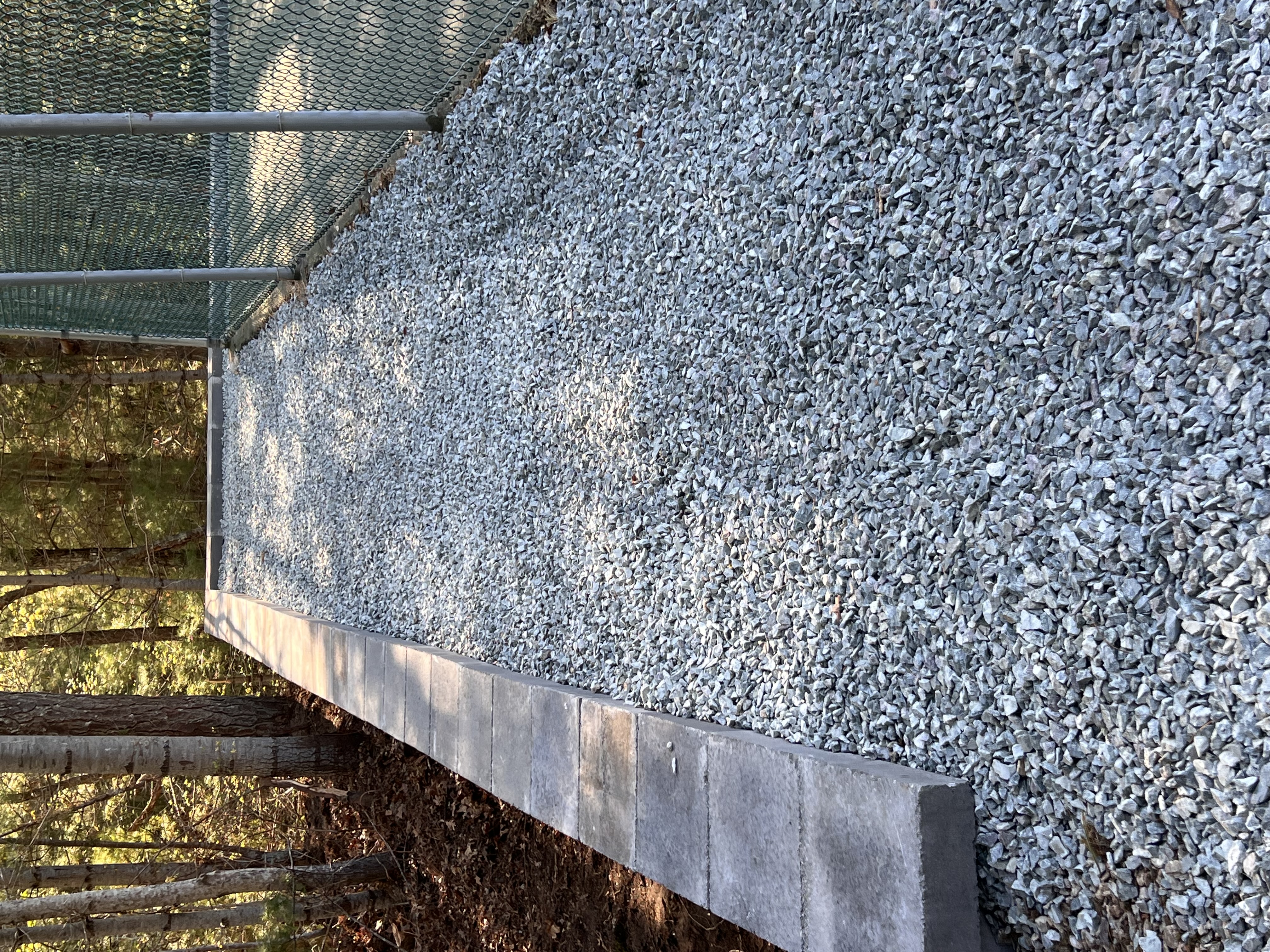 Crushed stone driveway and retaining curb border installation