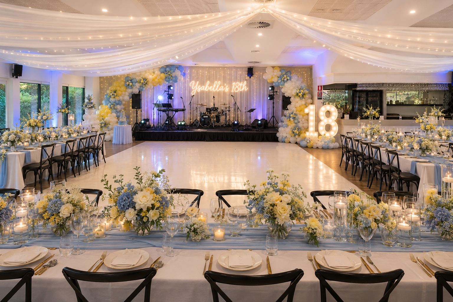 Indoor venue setup with dance floor and 18 sign