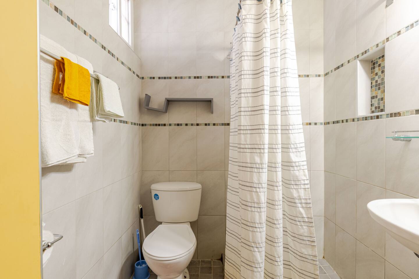 Clean Modern Bathroom with Tiled Shower & Fresh Linens