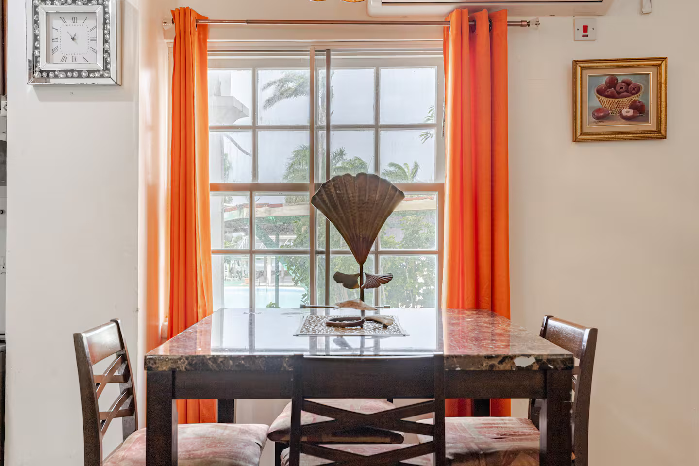 Sunny Dining Table with Courtyard Pool Views & Island Accent Curtains