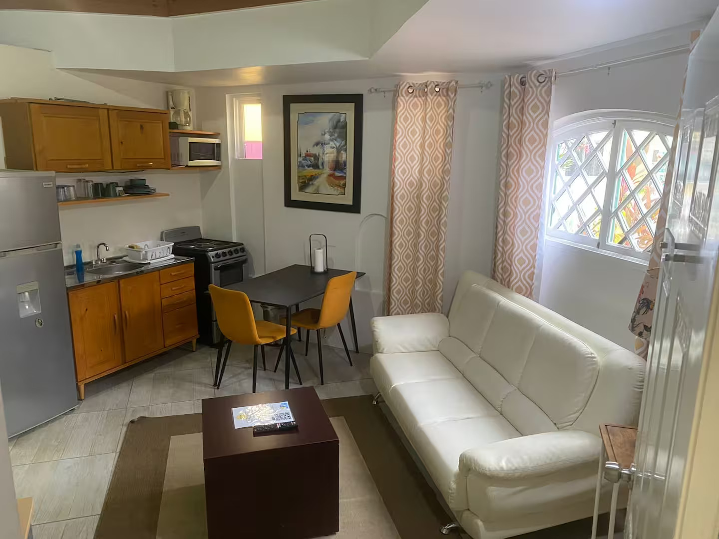 Open-Concept Living & Dining Space with White Leather Sofa & Kitchen