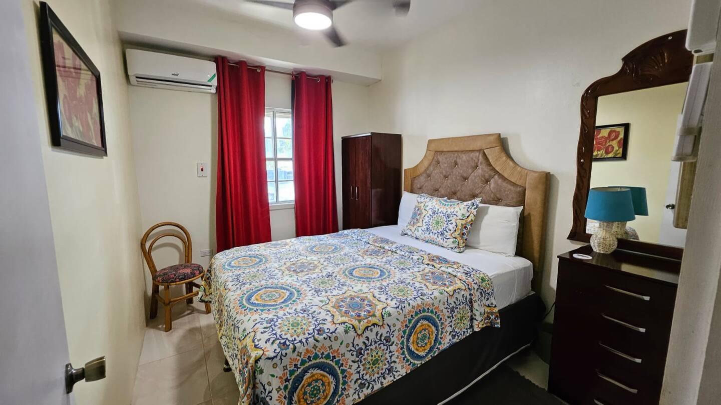 Master Bedroom with Tufted Headboard, Vanity Dresser, Ceiling Fan & Split A/C