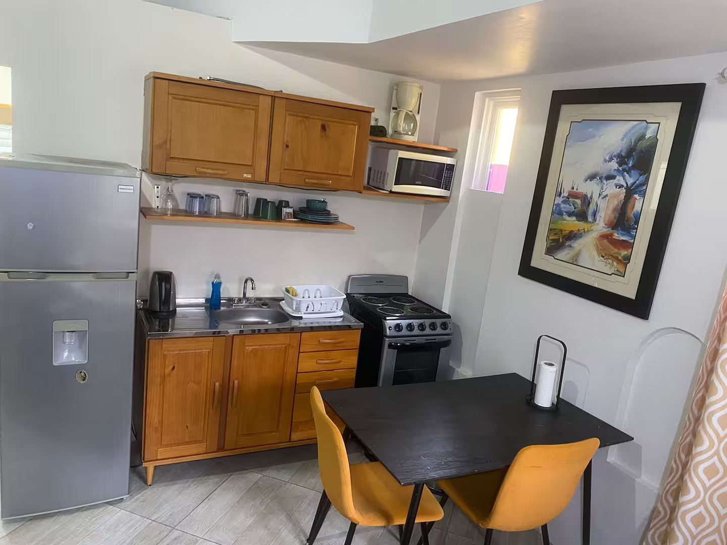 Fully Equipped Kitchen with Gas Range Stove, Refrigerator, Microwave & Dining Table