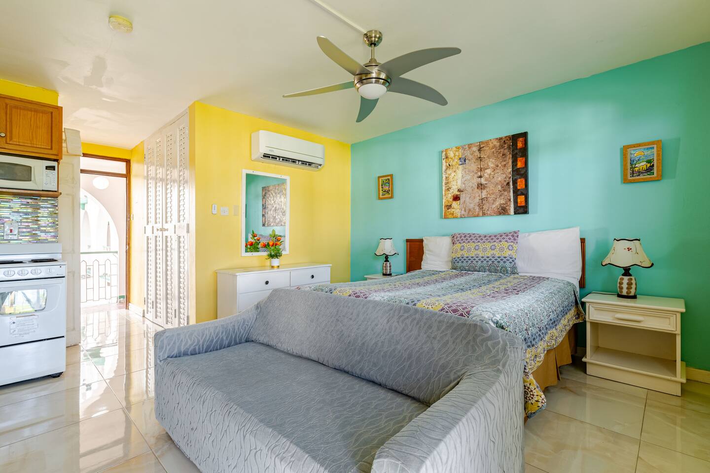 Spacious Suite Layout with Bed, Dresser & Balcony Access