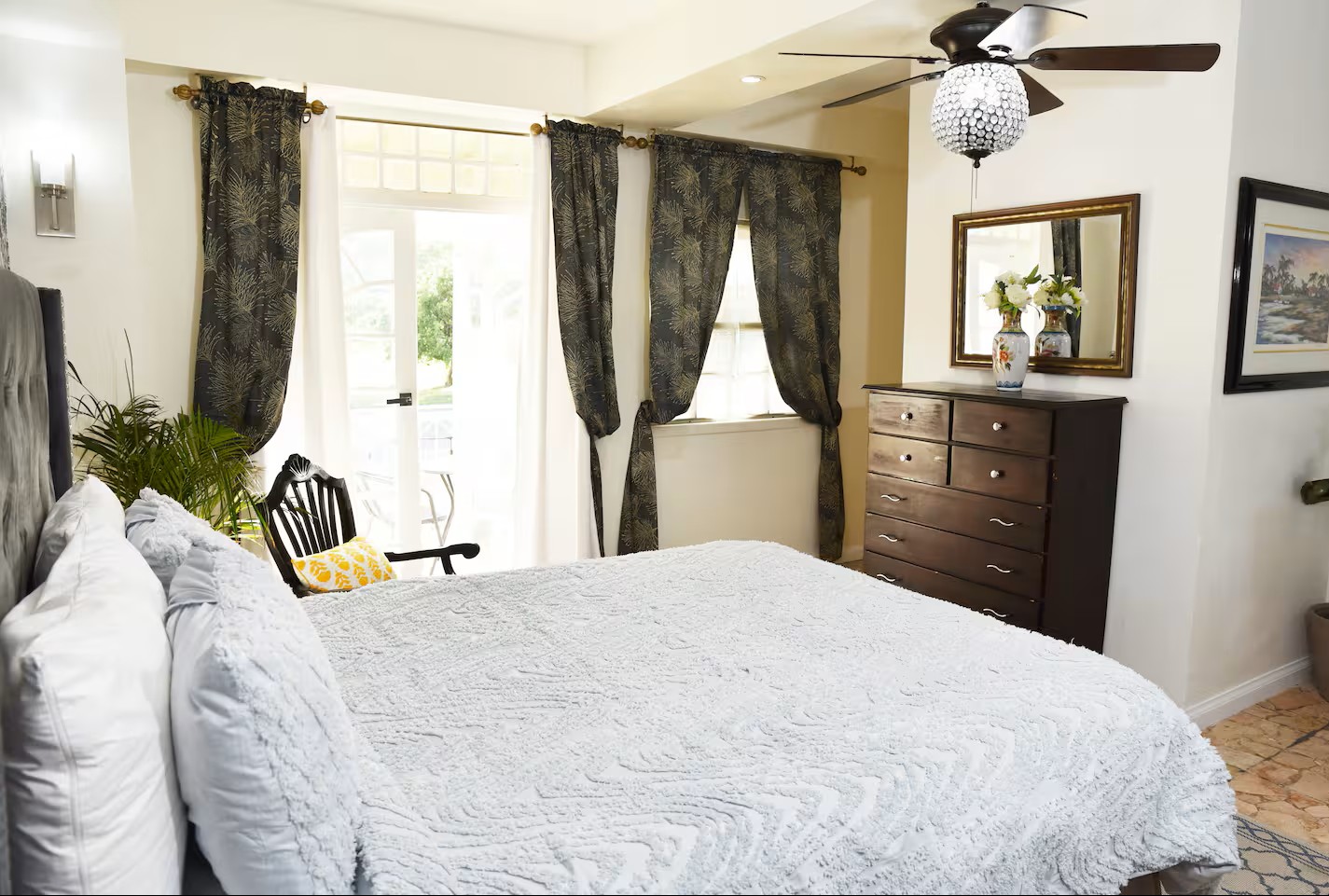 Plush Bed with French Doors Opening to Private Sunny Patio