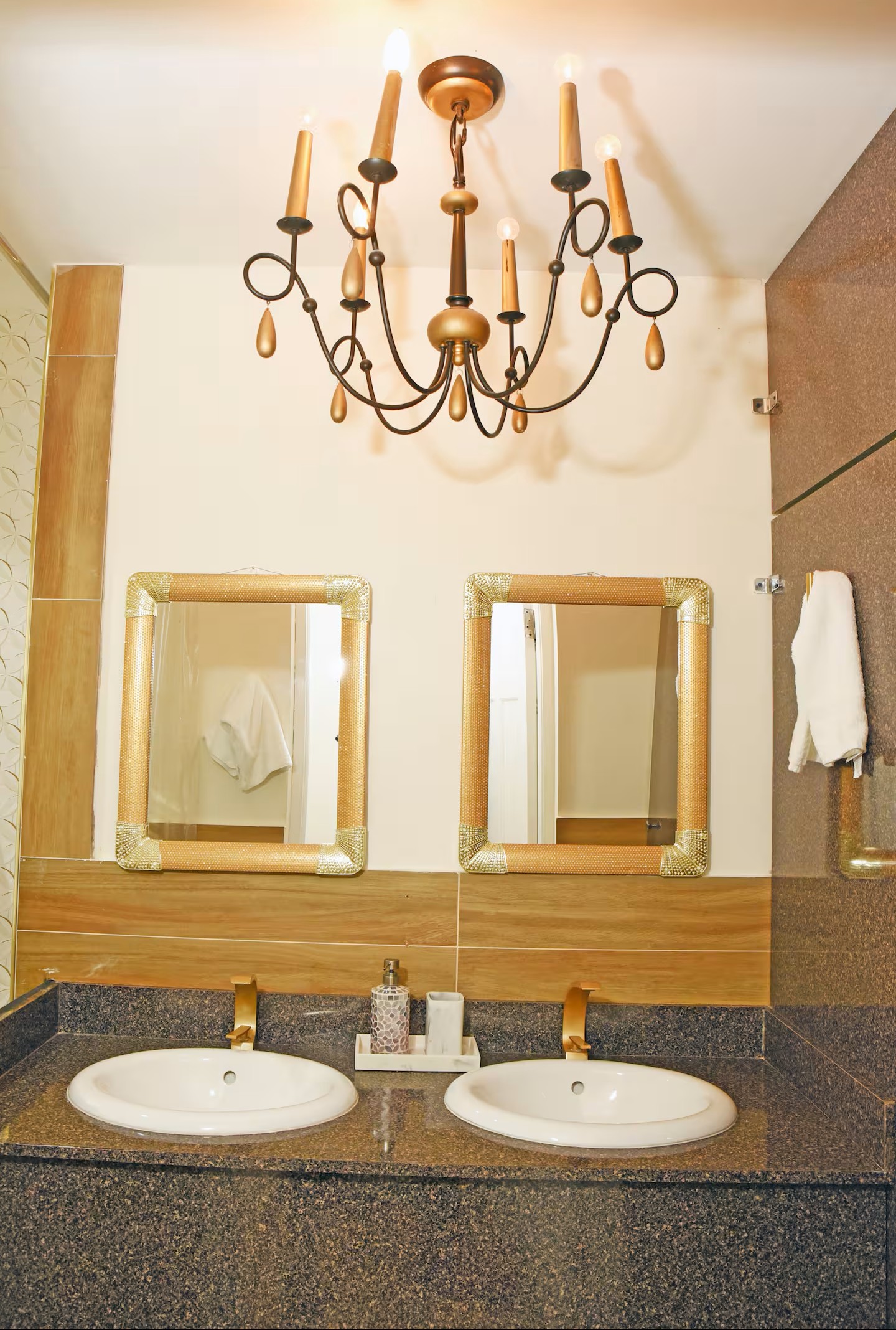 Double Vanity with Bronze Chandelier, Dual Sinks & Textured Gold Mirrors