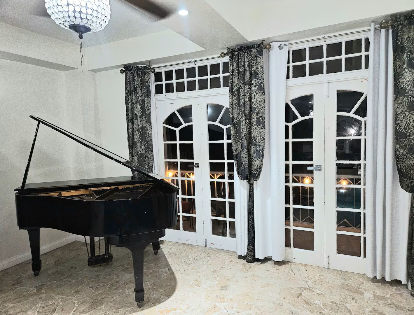 Grand Piano in Evening Salon Setting with Illuminated Balcony French Doors