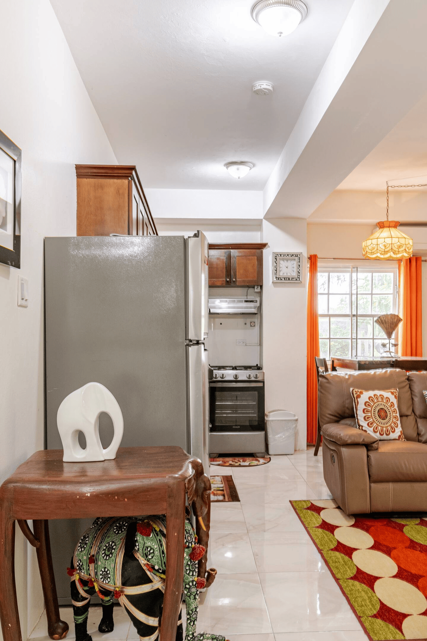 Open Living & Kitchen Perspective with Artisan Decor, Leather Recliner & Dining Area