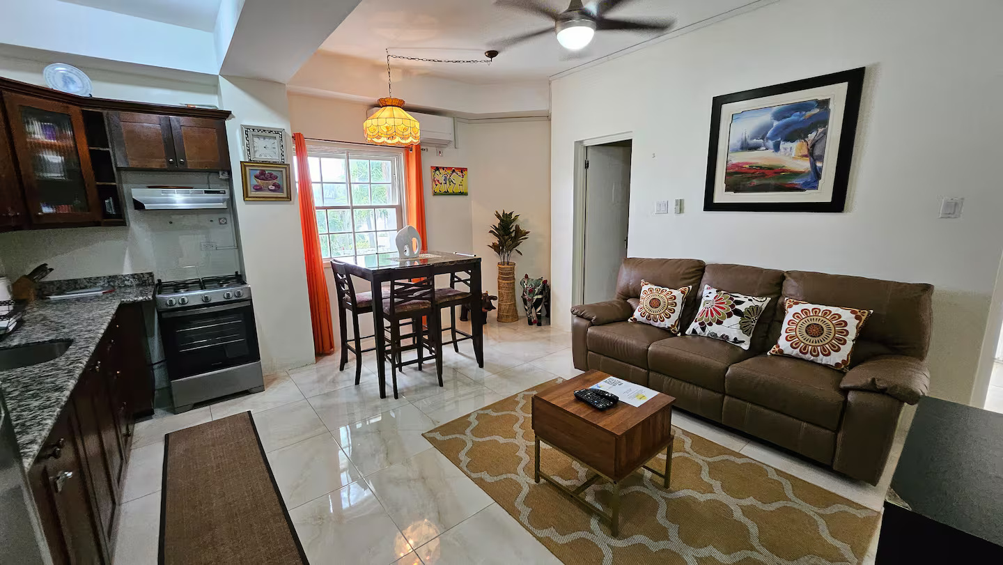 Panoramic Living Salon with Plush Leather Recliner, High-Top Dining Set & Full Chef's Kitchen