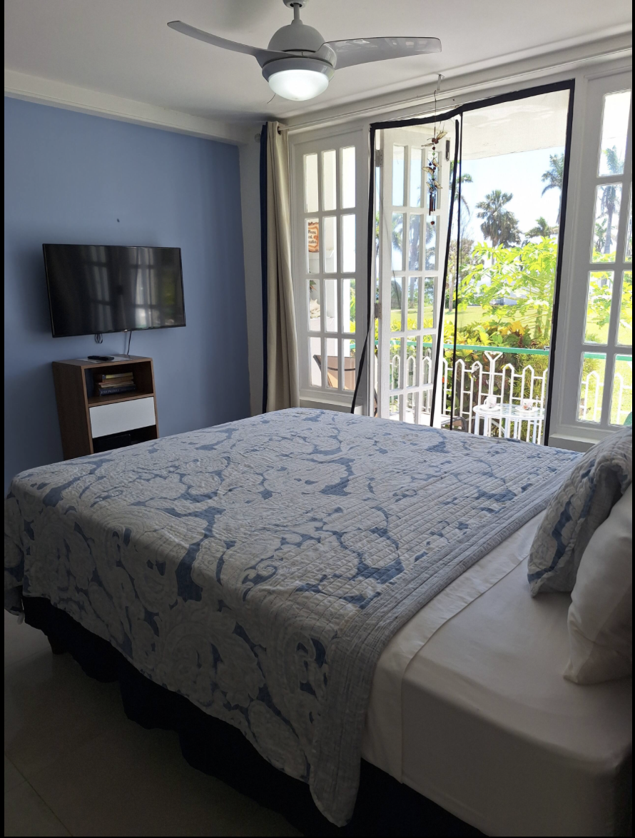 Comfortable Queen Bed with TV Entertainment & Direct Walk-Out to Garden Balcony