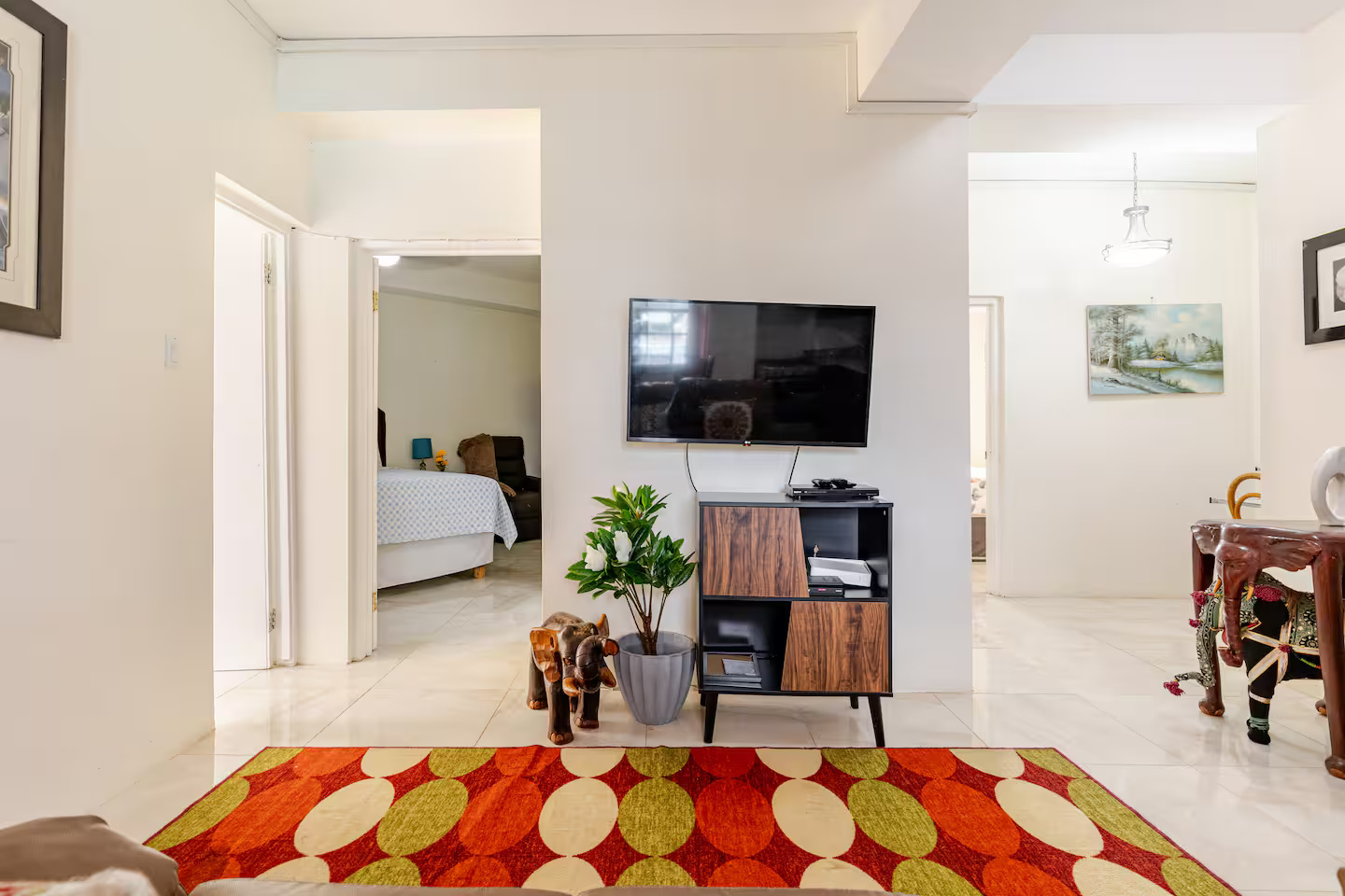 Central Hallway Foyer with Media Console, Smart TV, Artisan Decor & Bedroom Views