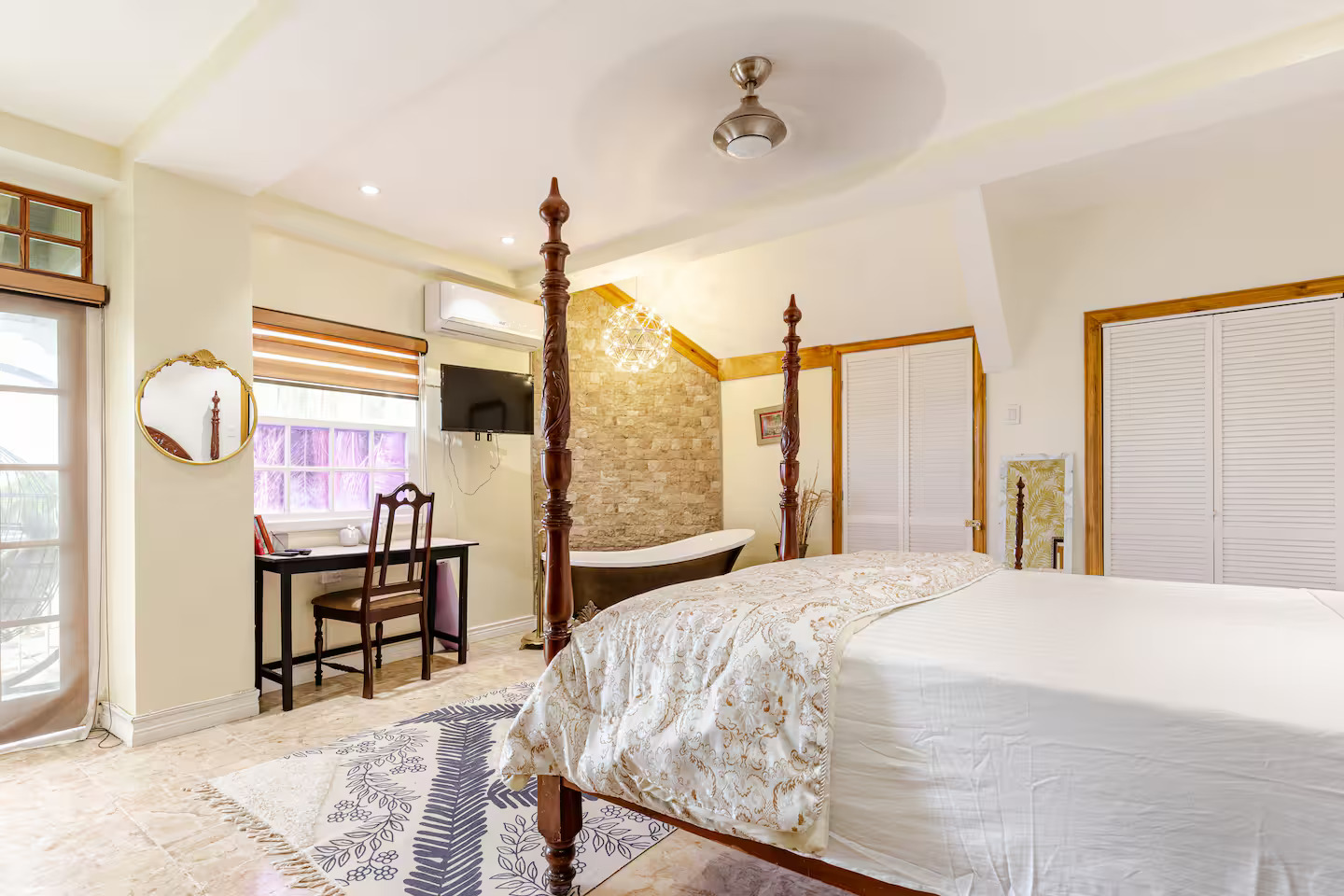 Master Bed Perspective Looking Towards Illuminated Stone Wall & Tub