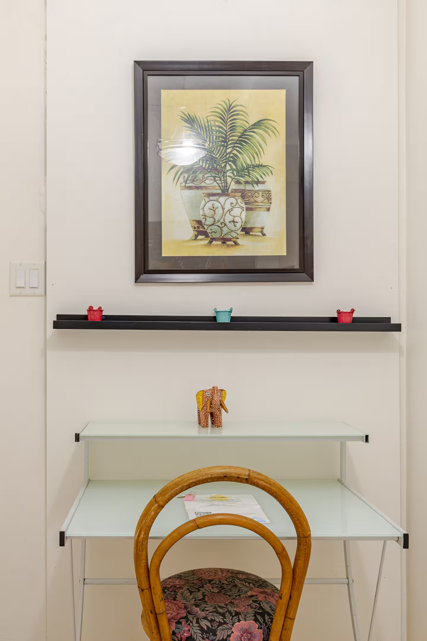 Dedicated Work Desk with Rattan Chair, Floating Display Shelf & Tropical Botanical Art
