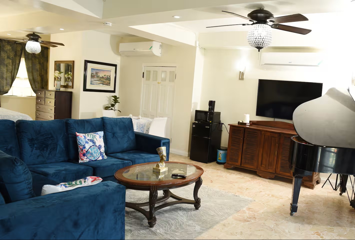 Living Room Lounge with Blue Velvet Couch, Media Console & Smart TV