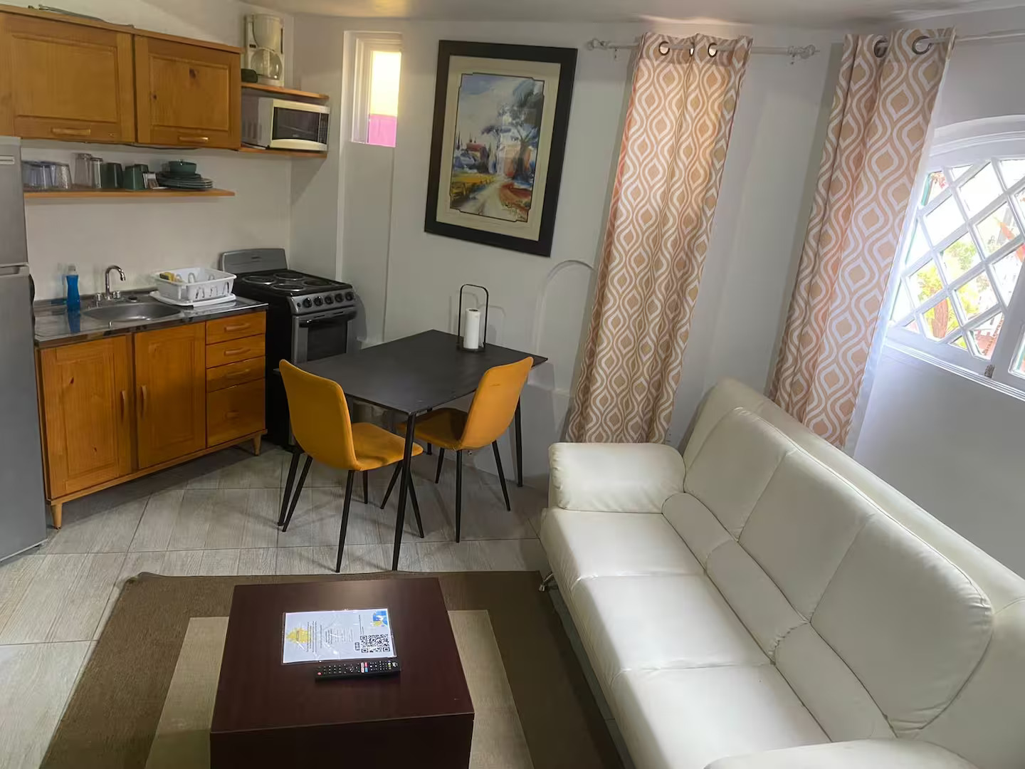 Spacious Living Salon with Modern White Sofa, Coffee Table & Dining Table
