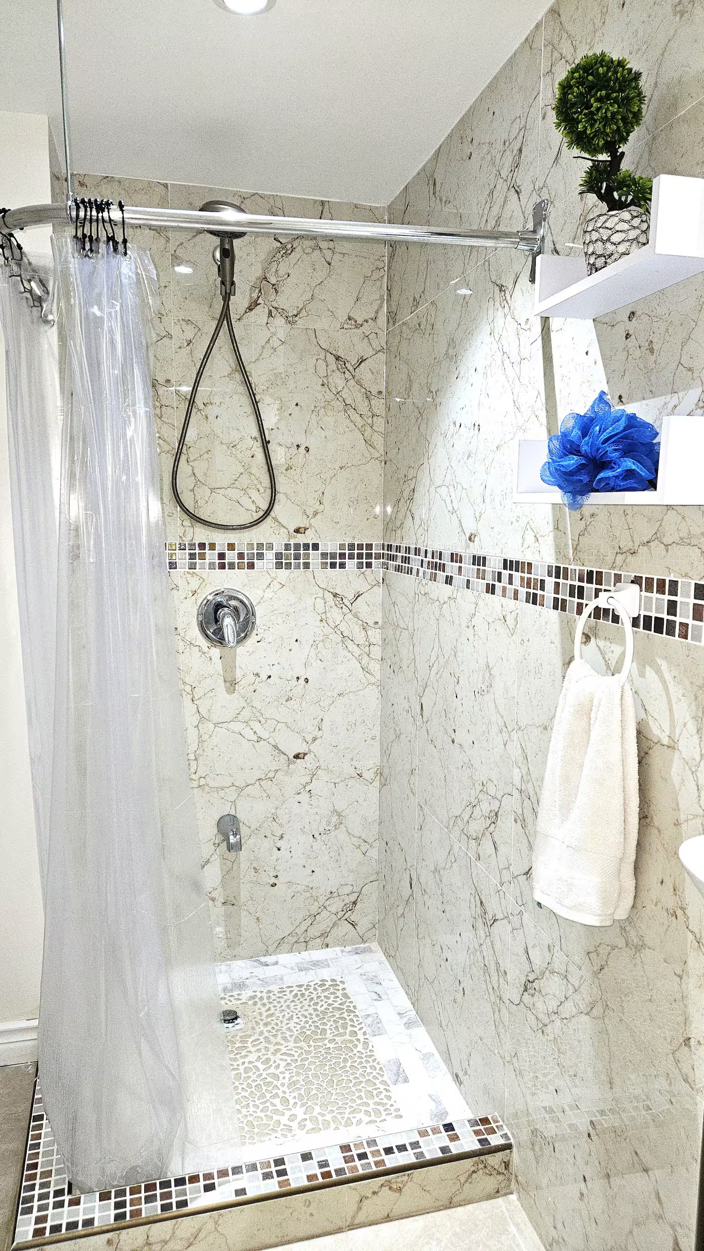 En-suite Marble Tiled Shower with Mosaic Accents