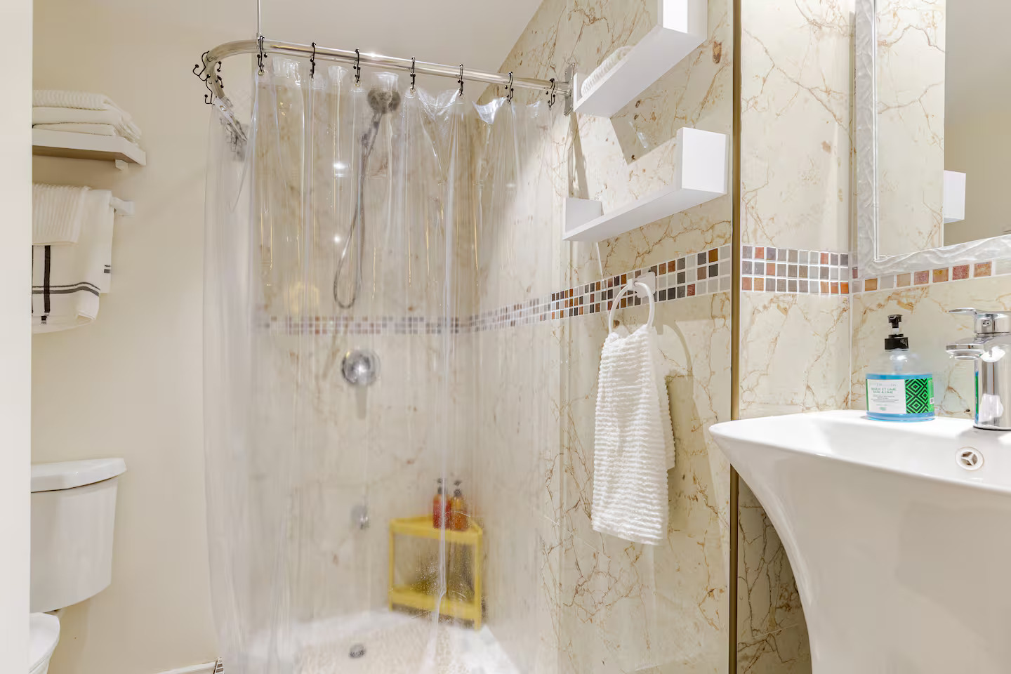 Marble-Tiled En-Suite Walk-In Shower with Floating Shelves & Fresh Towels