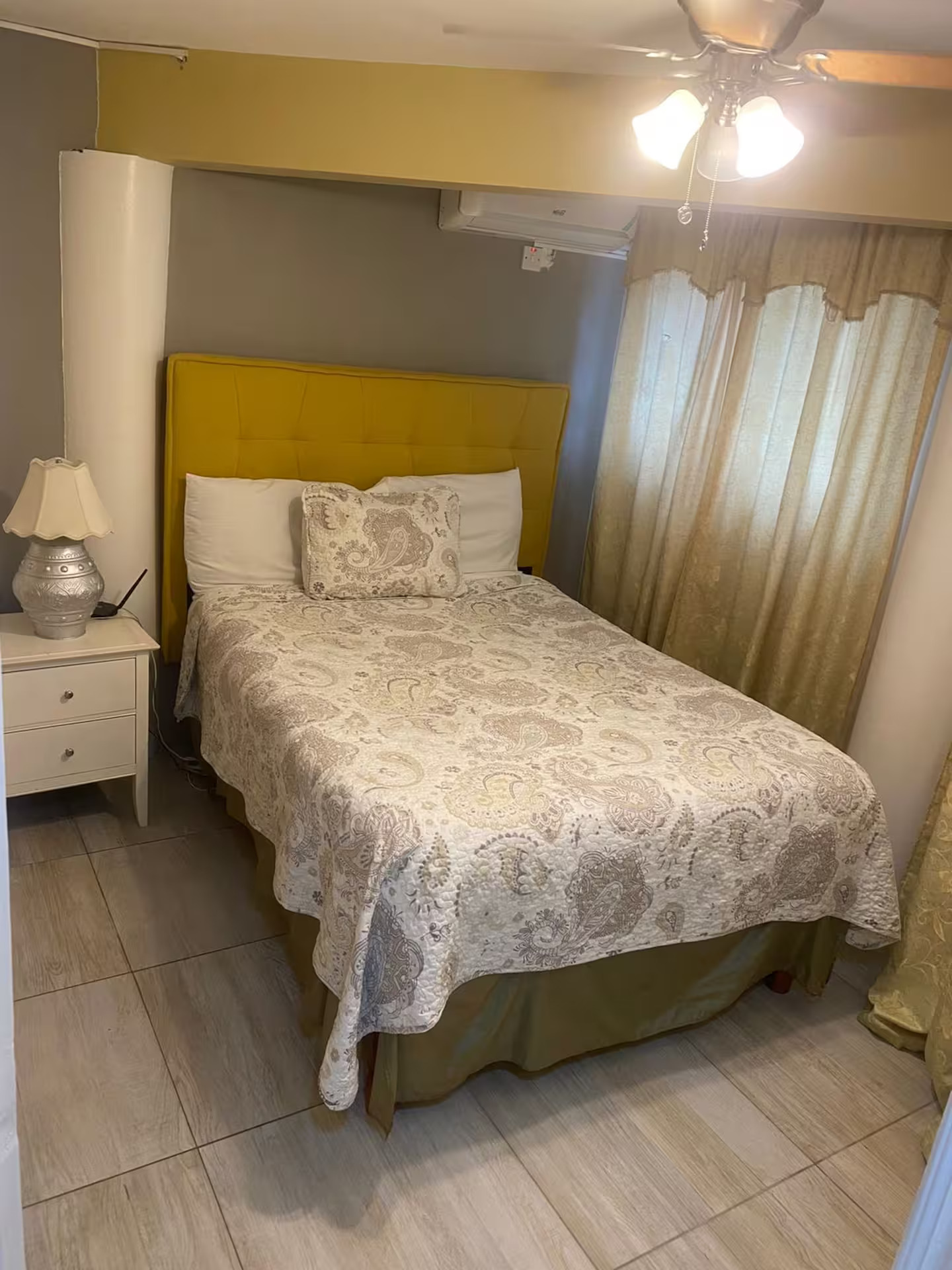 Bright Bedroom with Mustard Tufted Headboard, Ceiling Fan & Air Conditioning