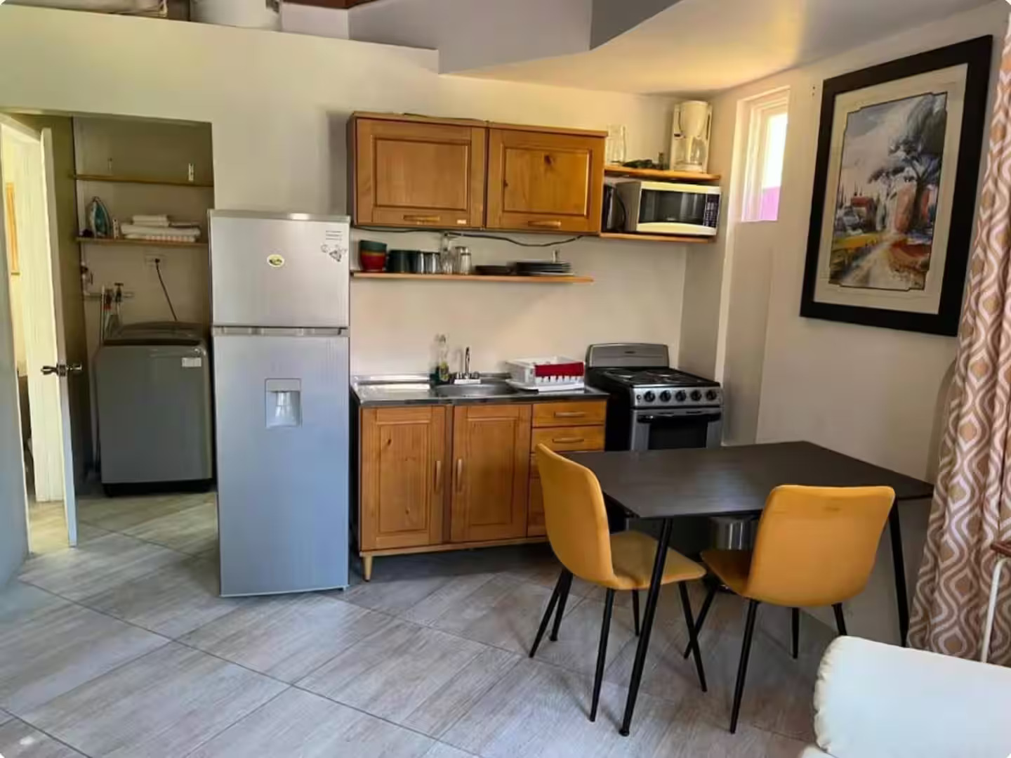 Spacious Open Kitchen & Dining Area with Adjacent In-Unit Laundry Room