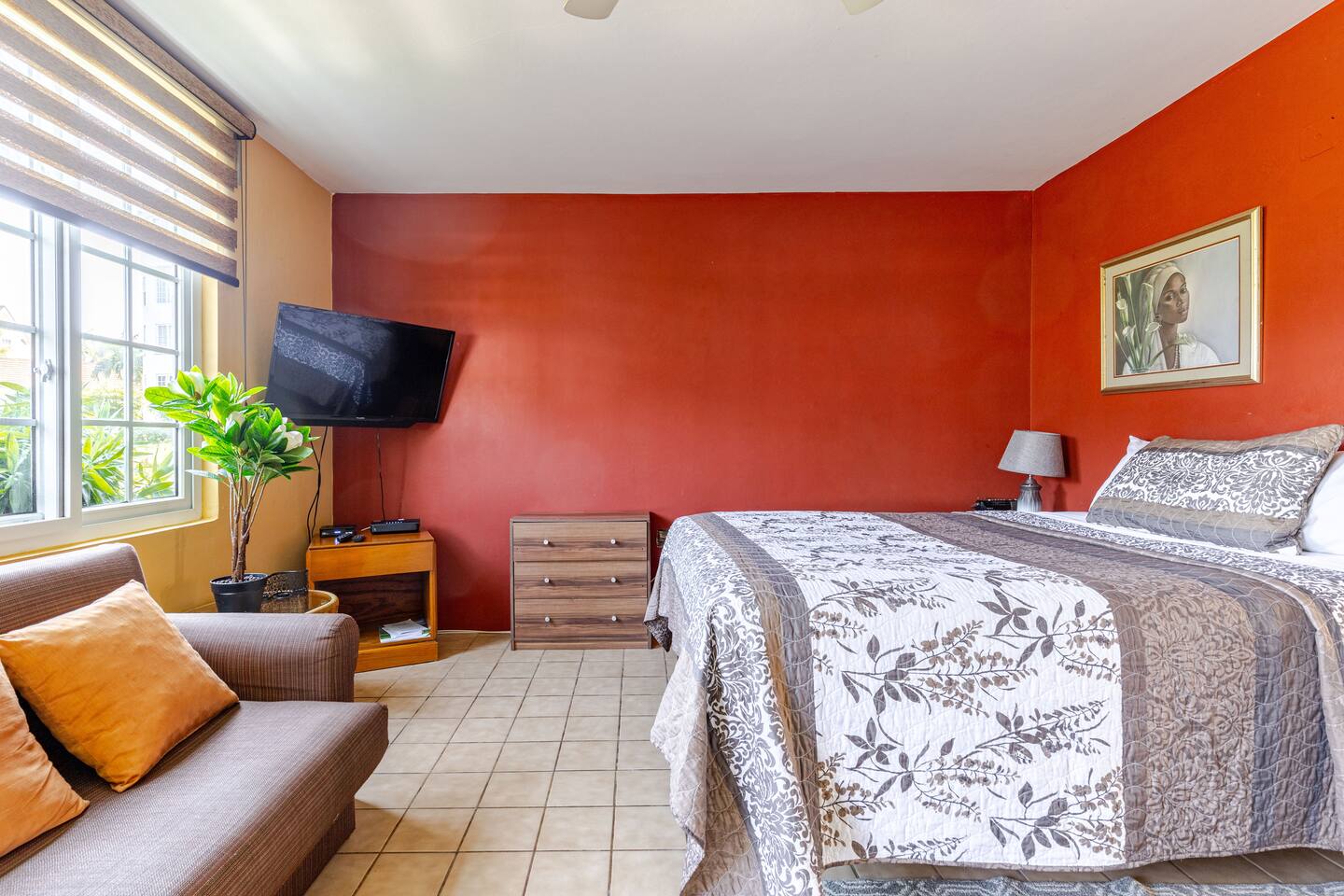 Cozy Master Bed, Dresser & Flat-Screen TV with Terracotta Accent Wall
