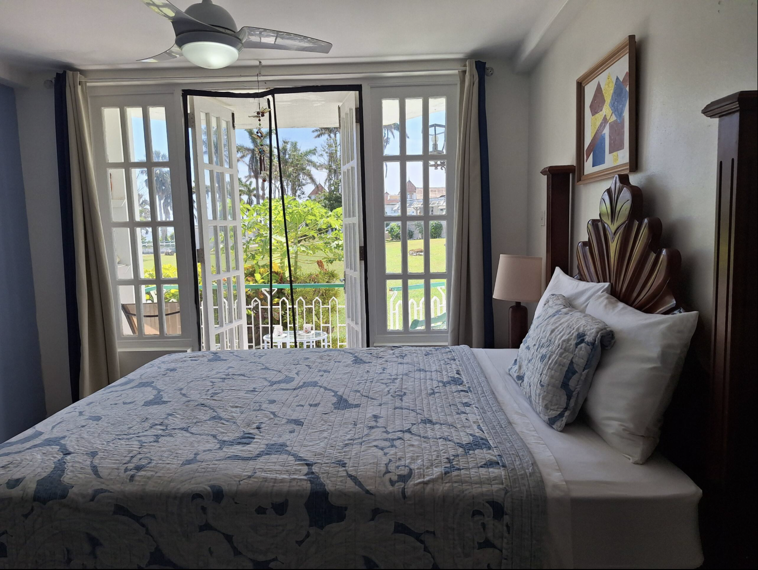 Bedroom Looking Out French Doors to Private Veranda with Tropical Garden & Estate Views