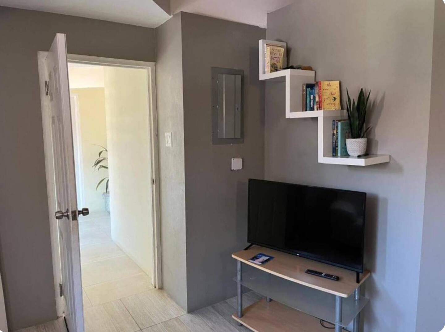 Media Station with Smart TV & Floating Geometric Bookshelf Decor