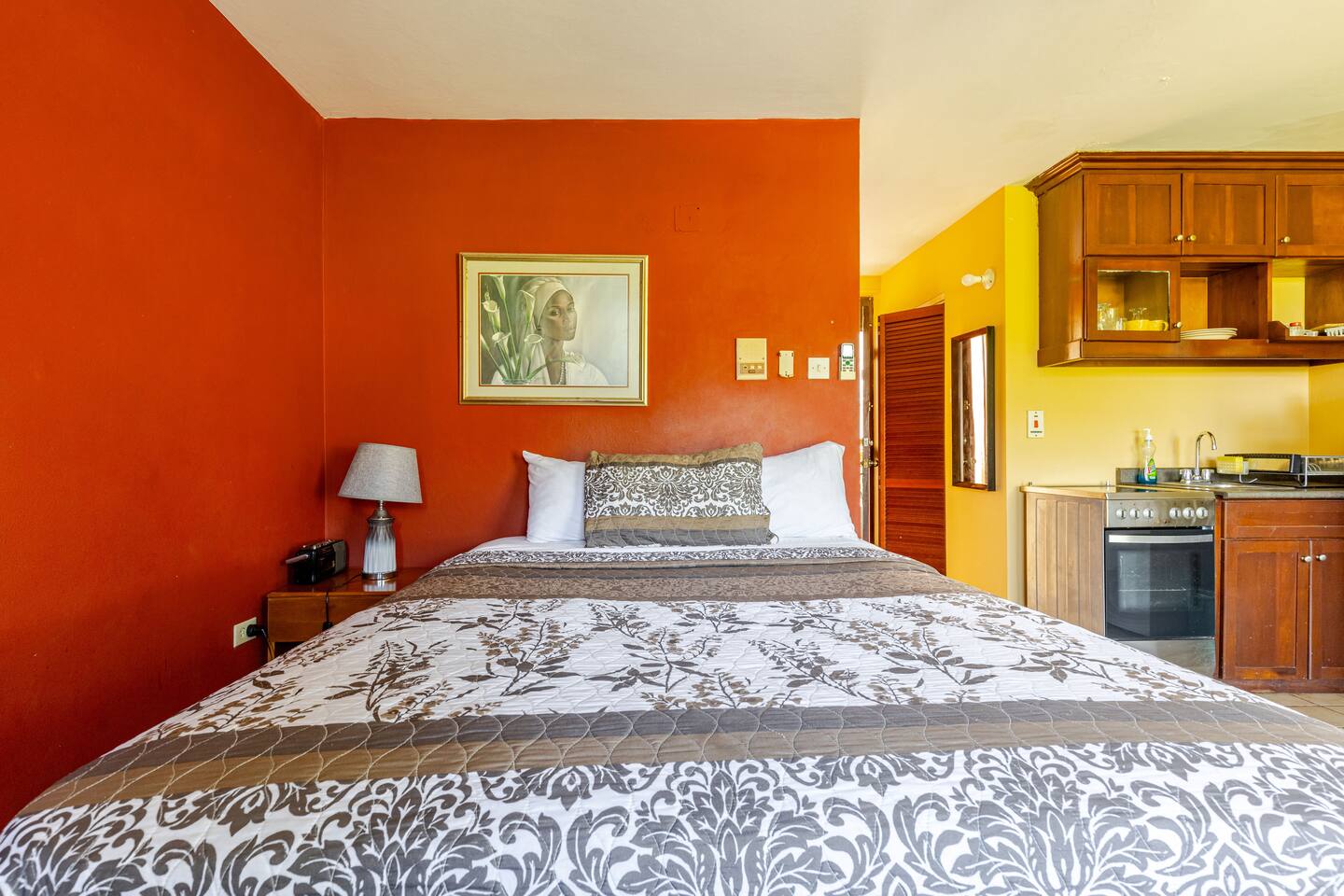 Cozy Bed with Terracotta Feature Wall & Decorative Artwork