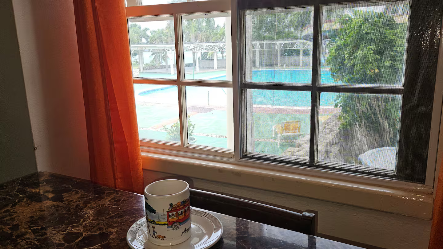 Morning Coffee by the Window with Picturesque Views of the Resort Pool & Palm Grounds