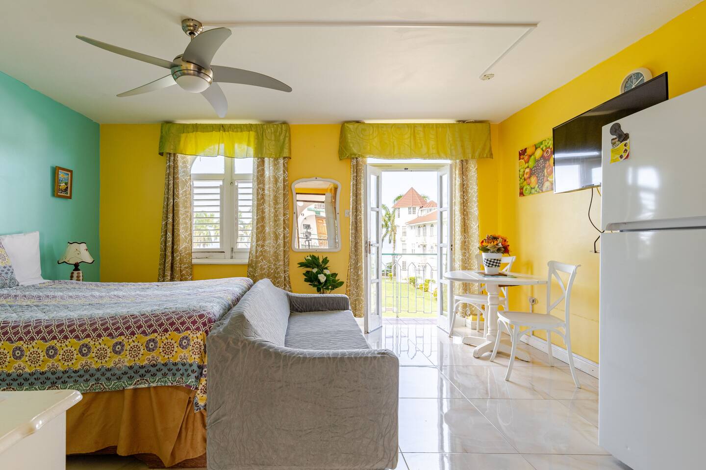 Dining Bistro Table, Flat Screen Smart TV & French Doors to Balcony