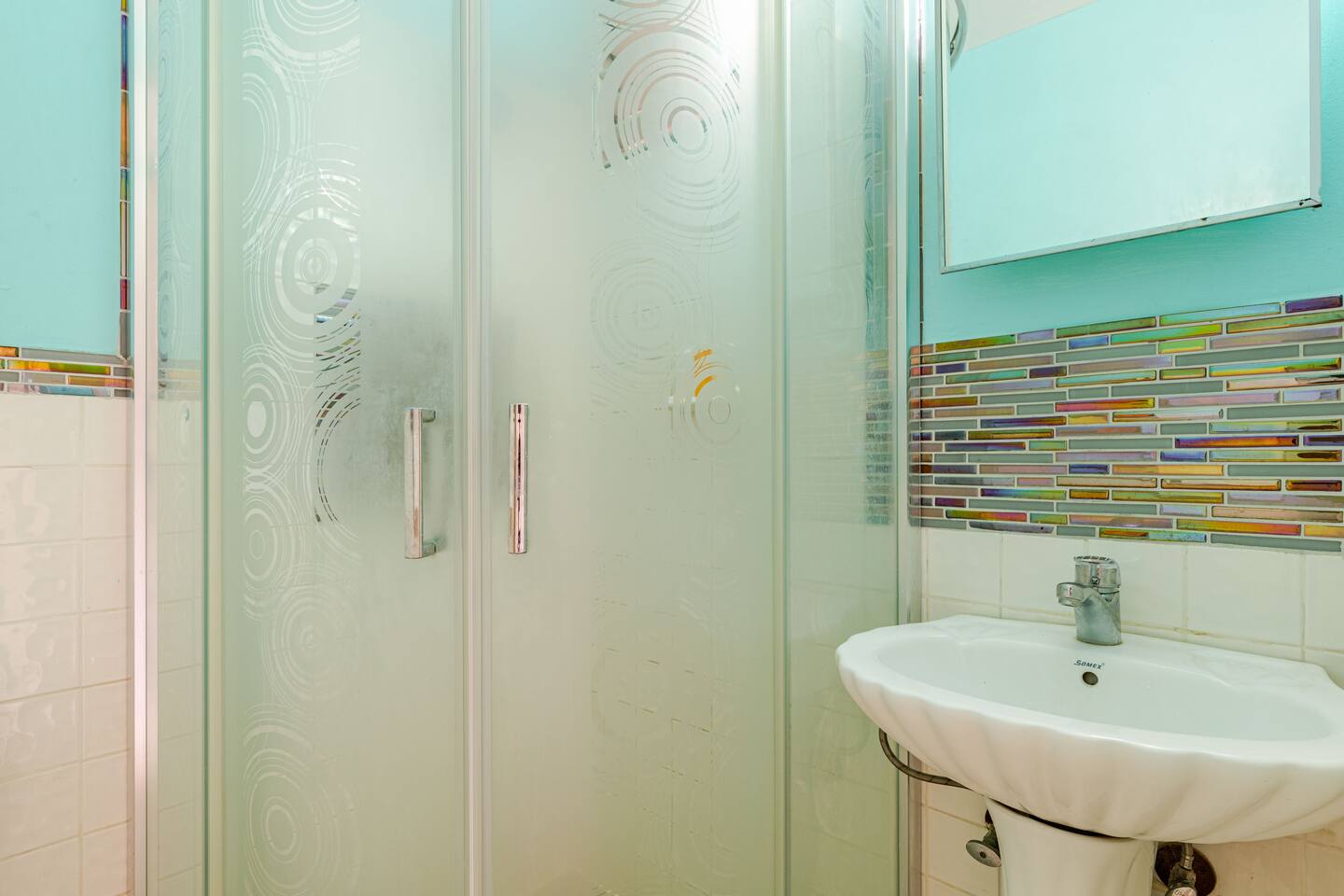 En-Suite Bathroom with Mosaic Tile Accents & Glass Shower