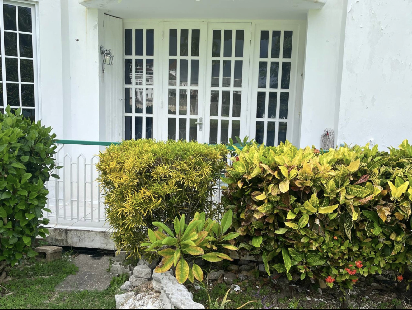Private Ground-Level Veranda Patio Surrounded by Tropical Crotons and Flowering Island Flora