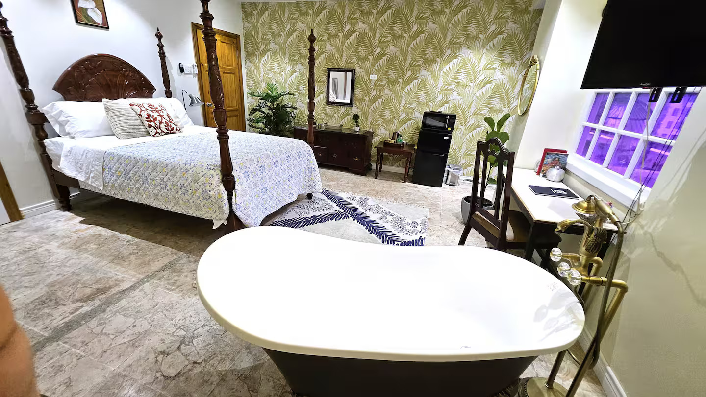 Tub Perspective Looking Towards Tropical Palm Wall, Four-Poster Bed & Workstation