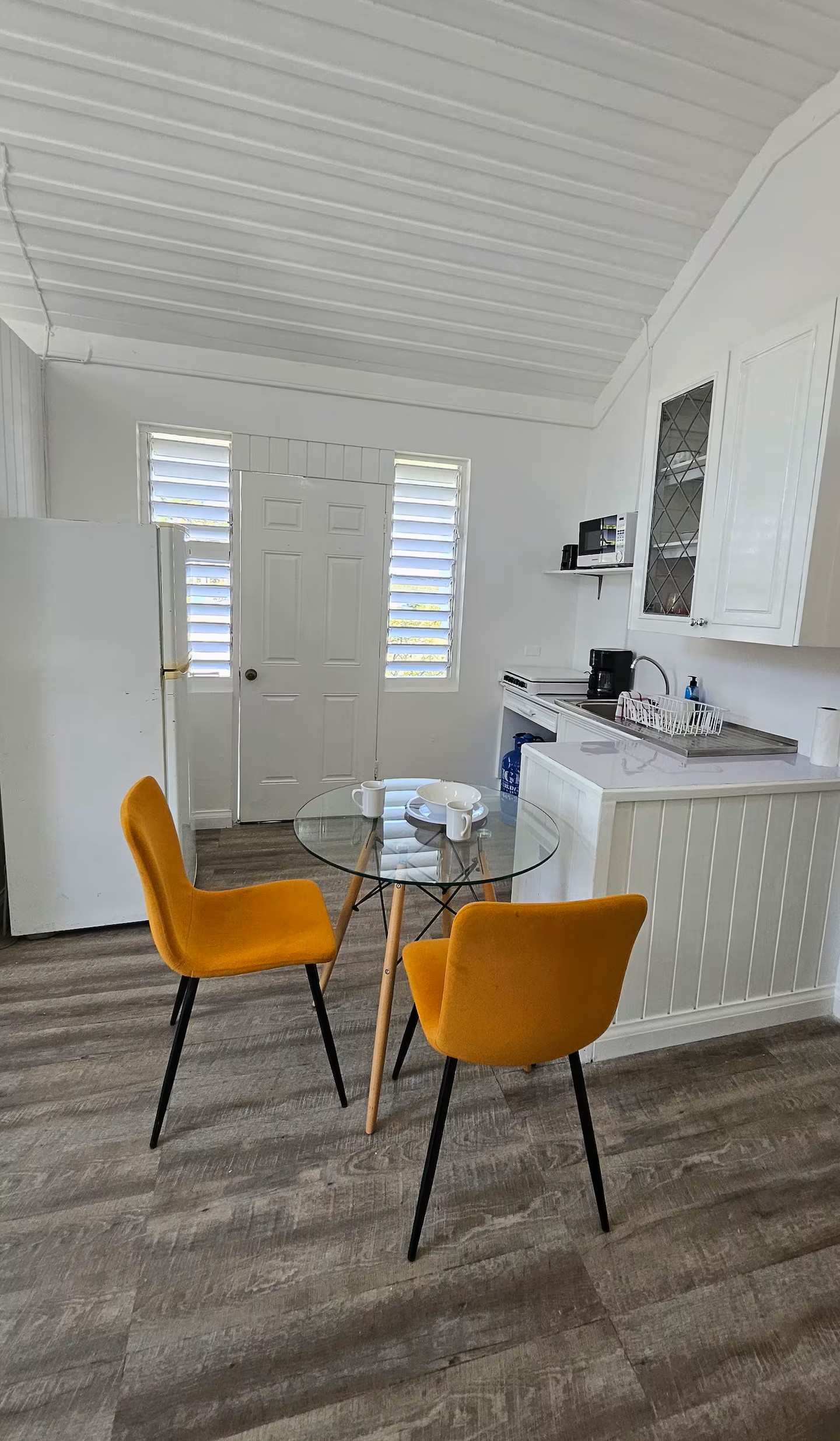 Dining Area with Glass Table, Modern Chairs & Kitchenette