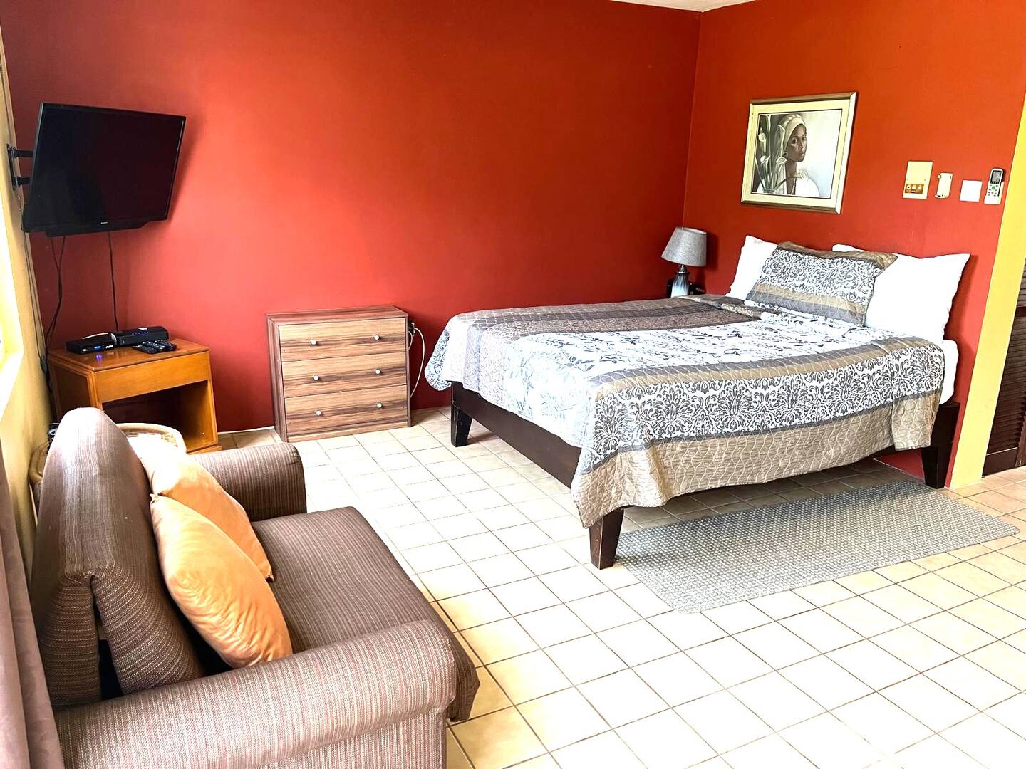 Spacious Studio Layout with Loveseat Sofa, TV & Bed
