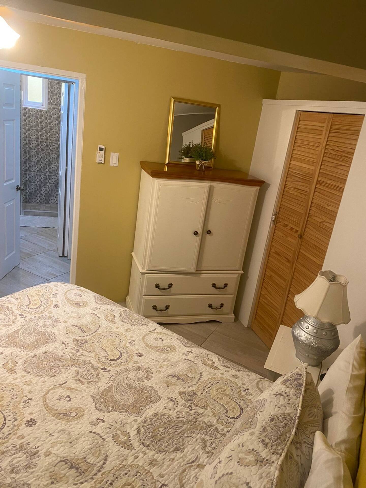 Master Bedroom with Vintage Armoire, Gold Accent Mirror & Ensuite Access