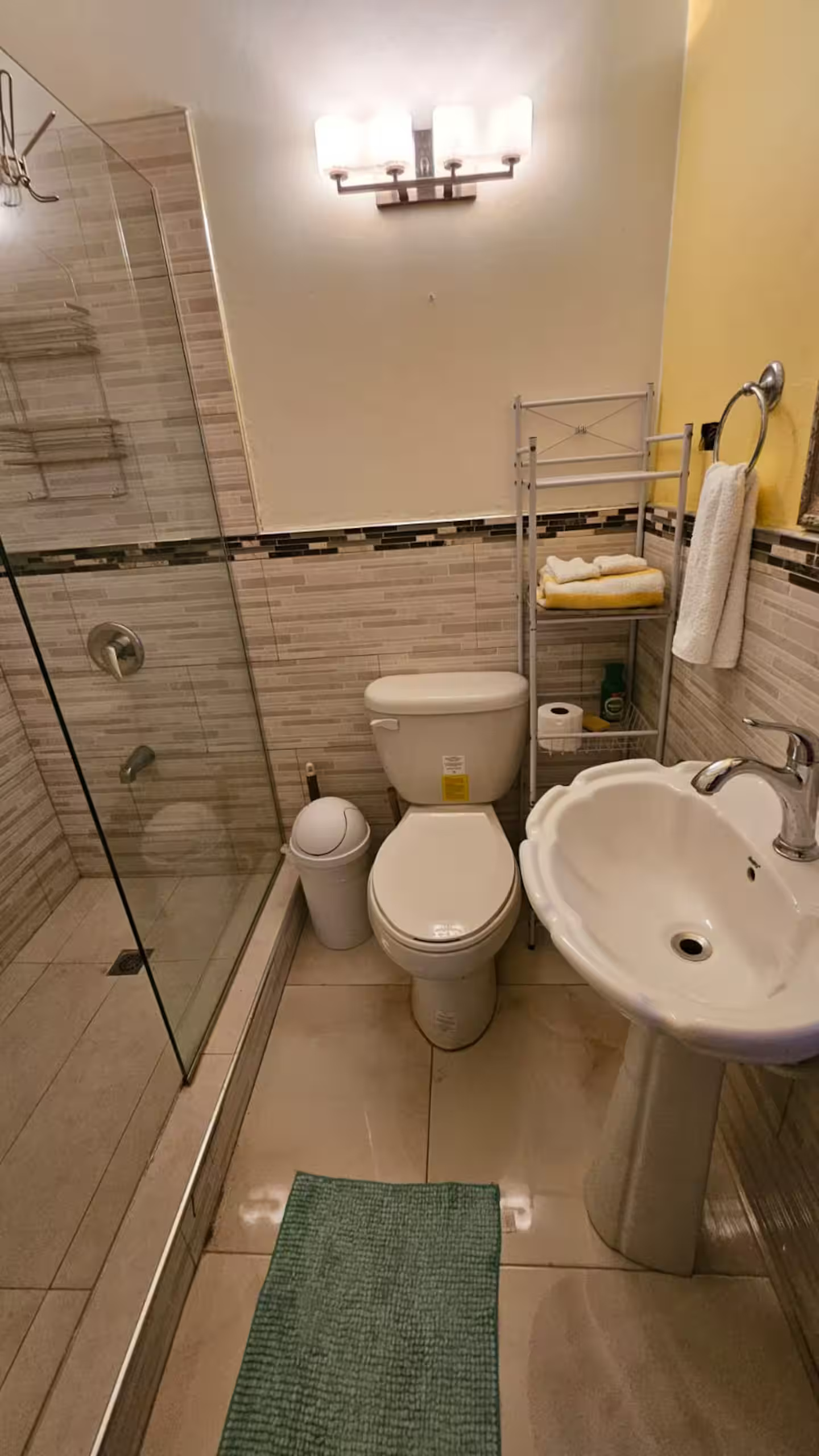 Tiled Bathroom with Glass Walk-In Shower, Pedestal Shell Basin & Fresh Towel Rack