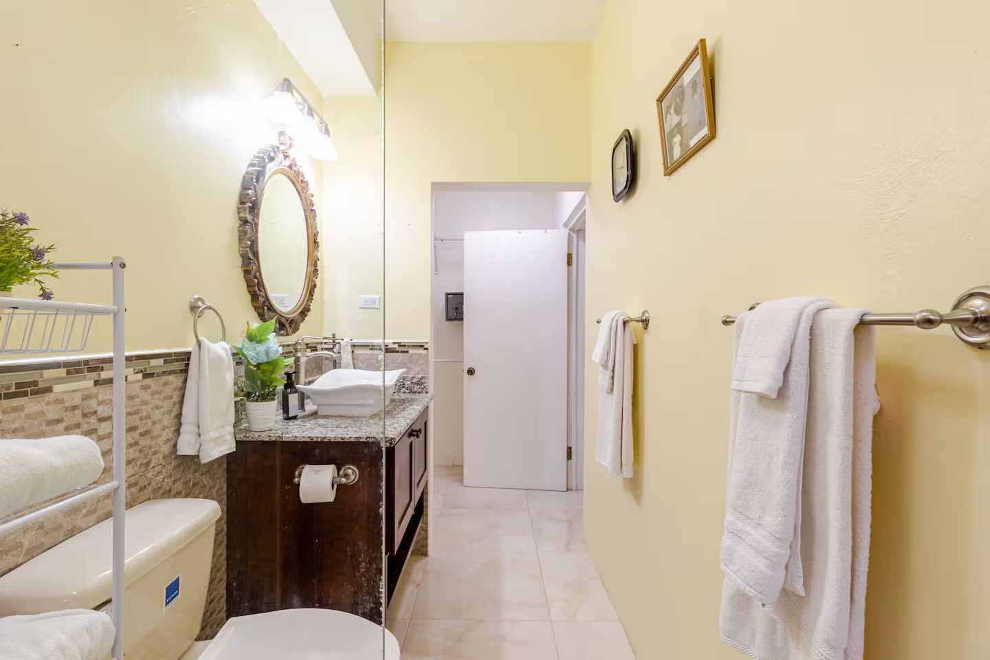 Modern Bathroom with Ornate Gilded Mirror, Glass Walk-In Shower & Fresh Linens