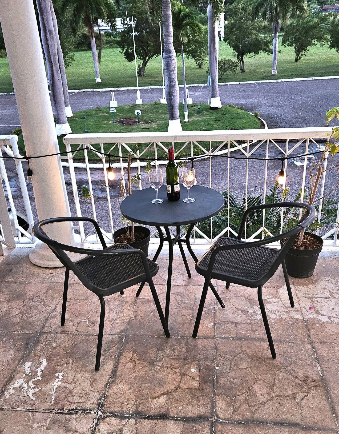 Private Balcony Bistro Seating with Wine Glasses & Evening Ambience