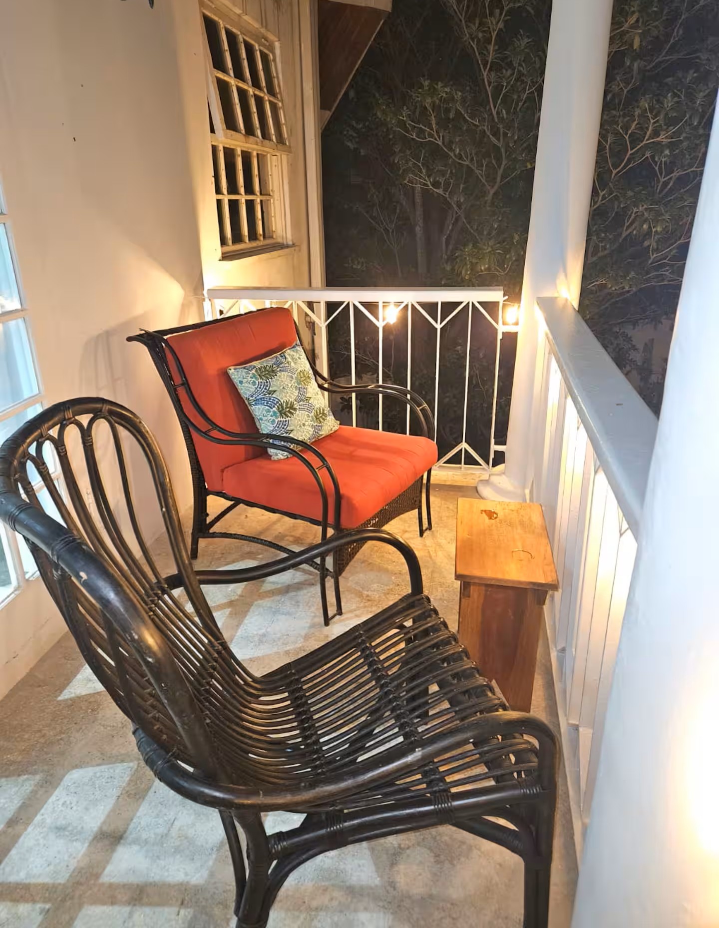 Evening Veranda with Ambient String Lights and Wicker Armchair Lounge