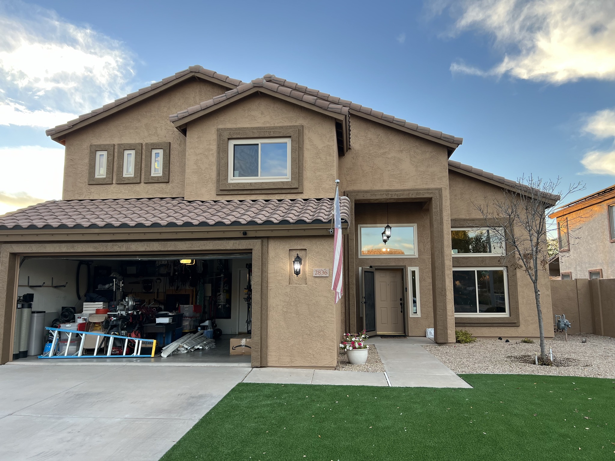 Brown stucco home with new windows