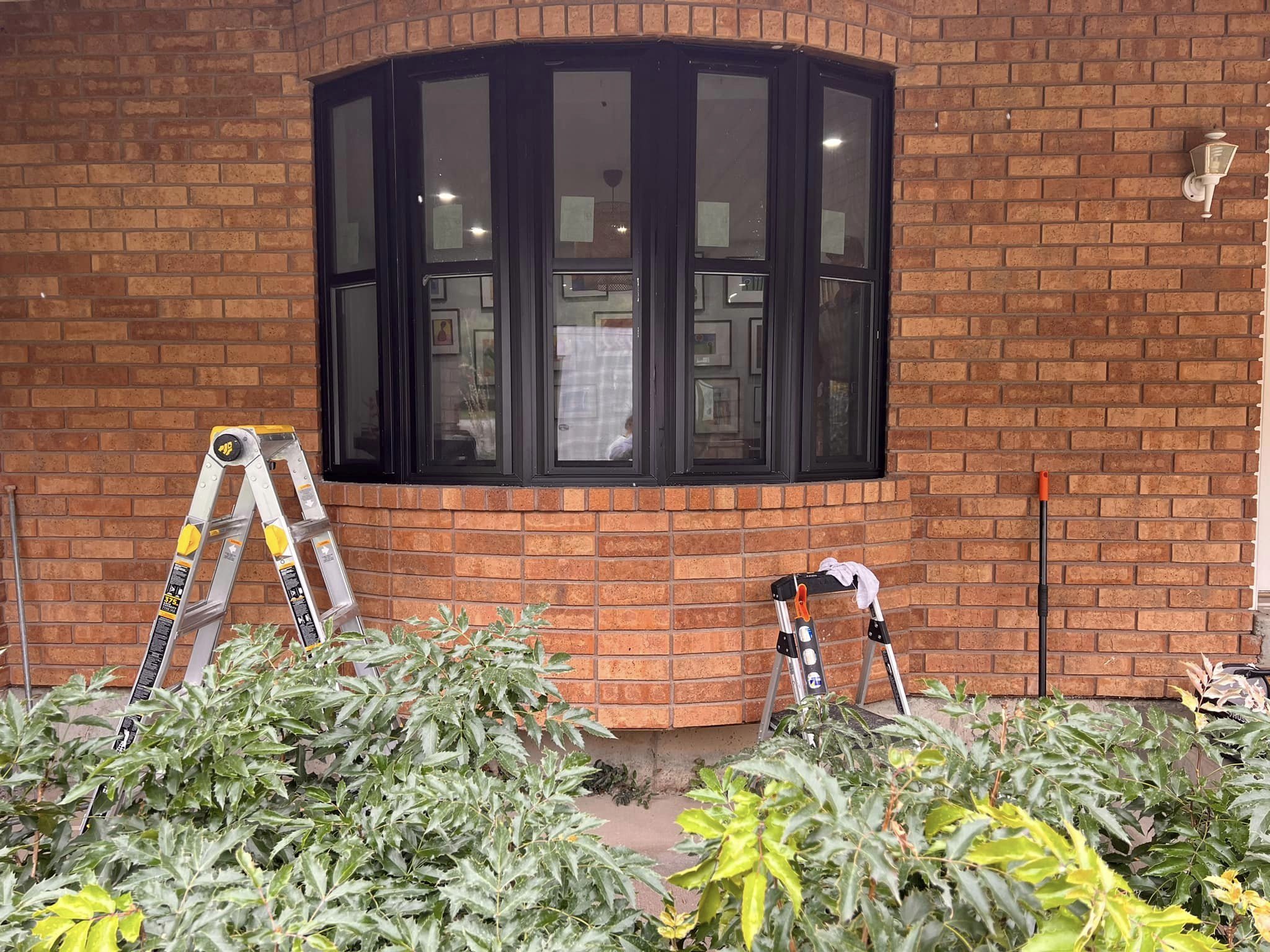 Black bay window on brick home