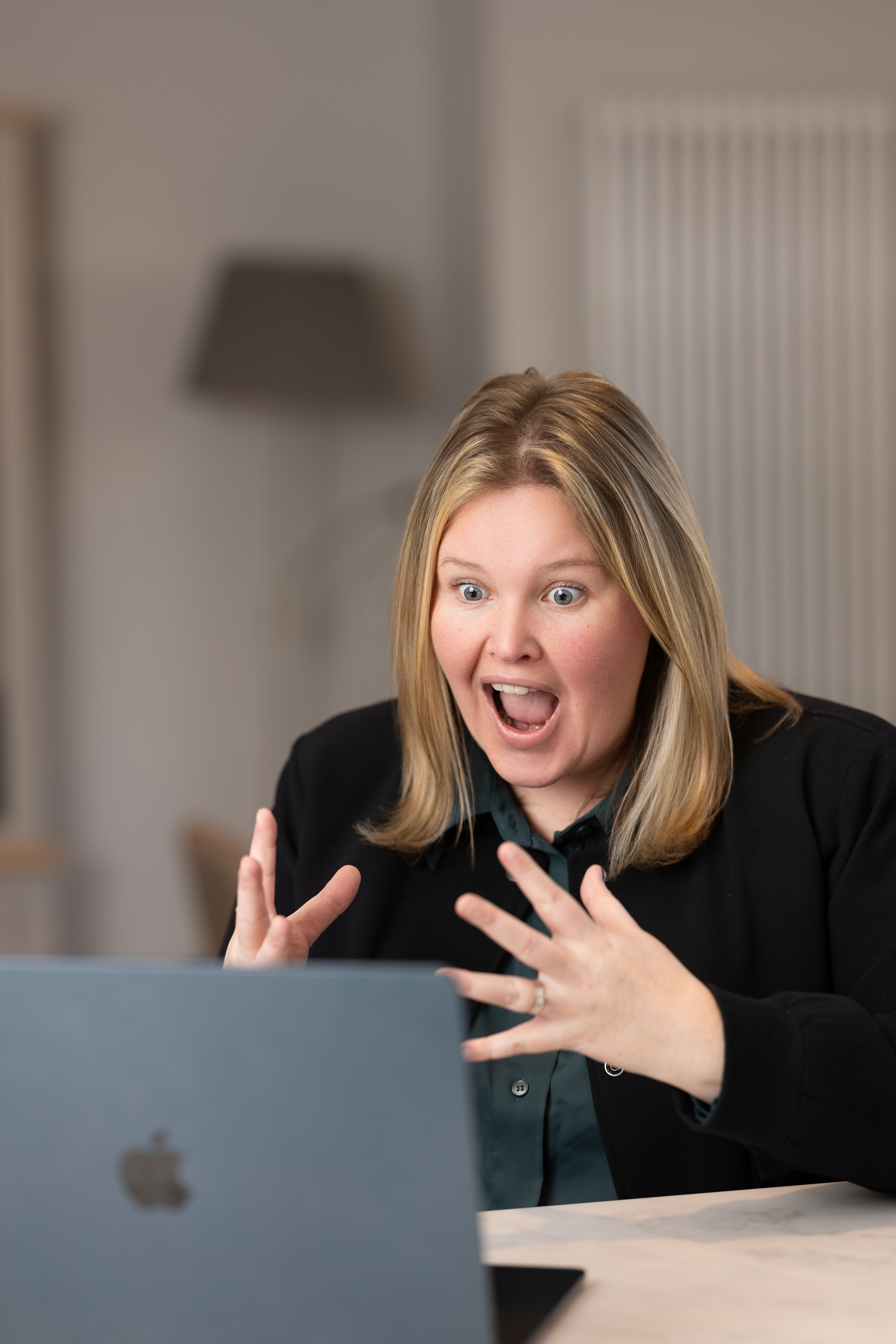 Georgie Thomas looking surprised at laptop