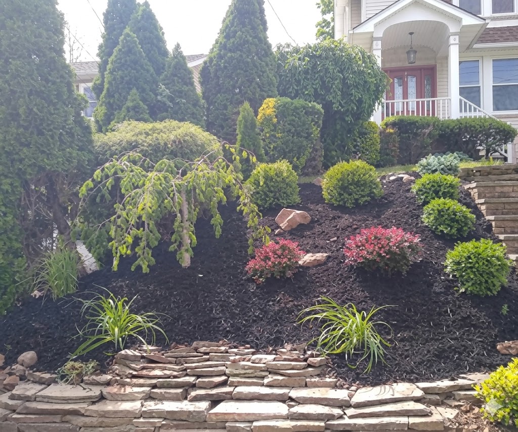 Beautifully landscaped front yard with masonry work