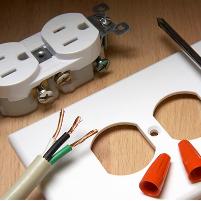 Electrical outlet parts and wires on a workbench