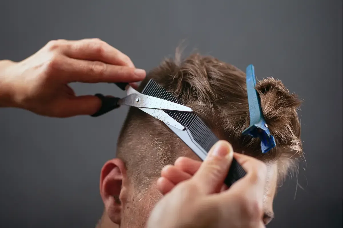 Barber cutting and blending haircut