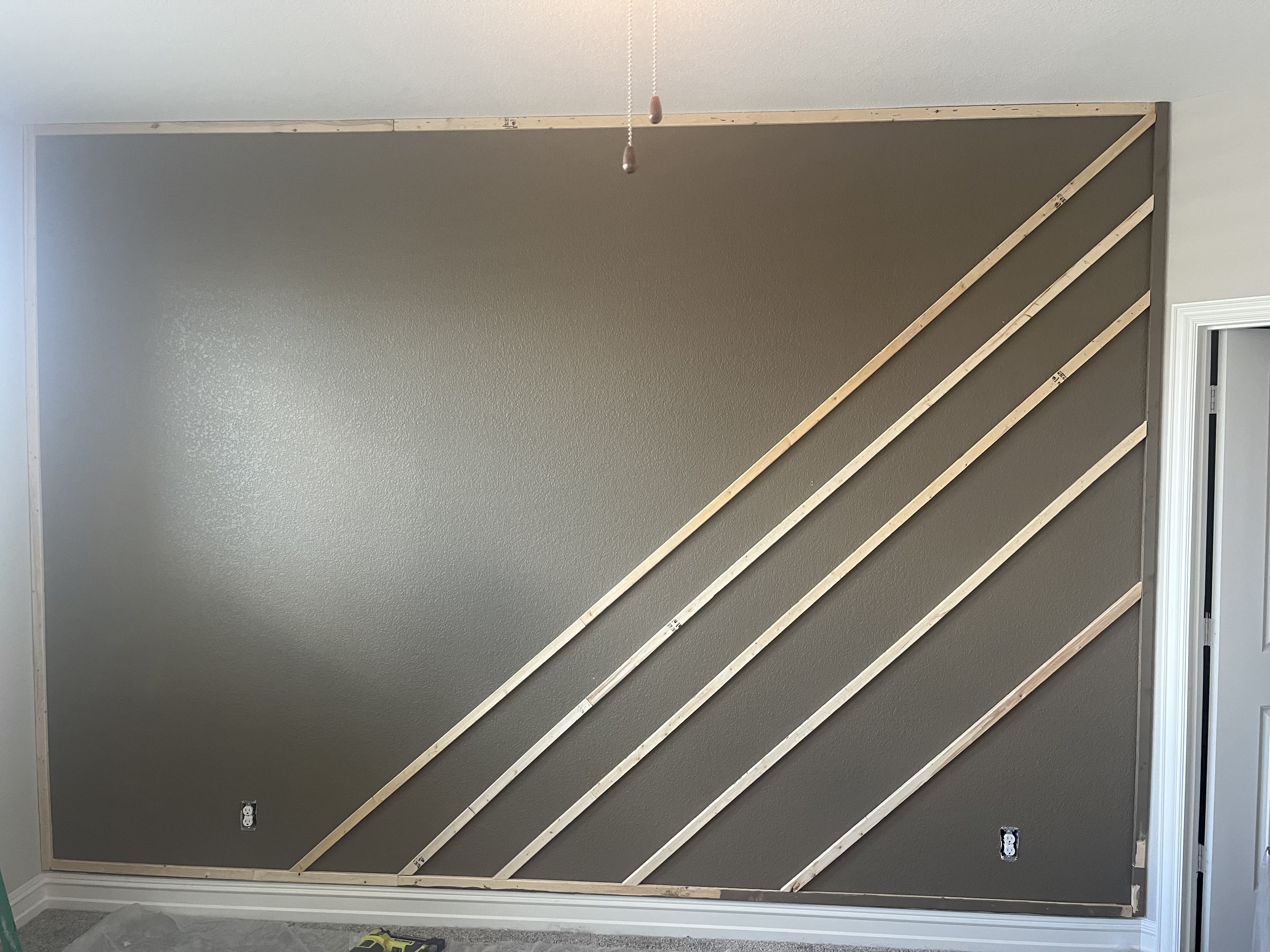 Custom accent wall framing process - diagonal wood slats