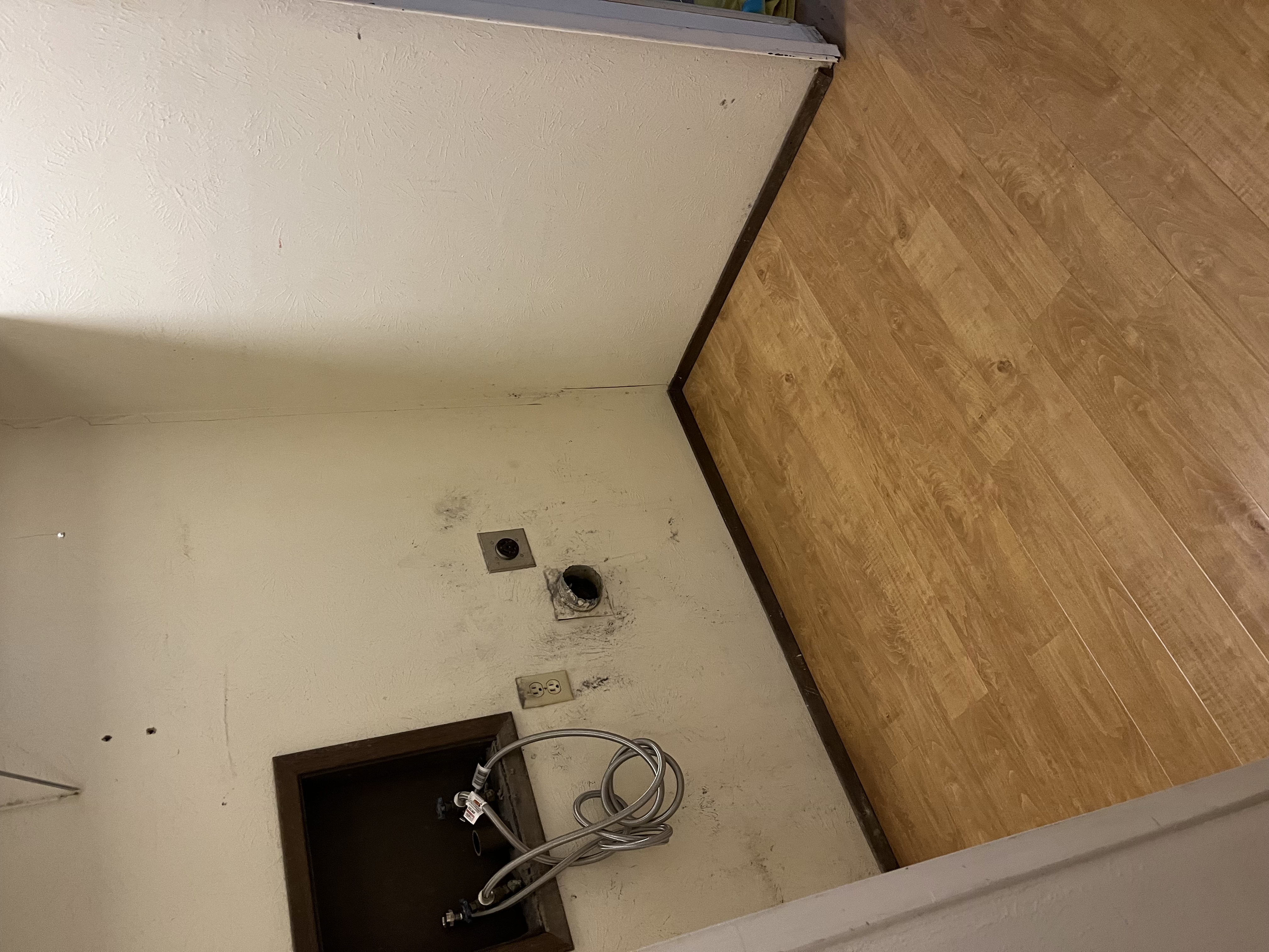 AFTER: Clean wood-look flooring installed in the laundry room