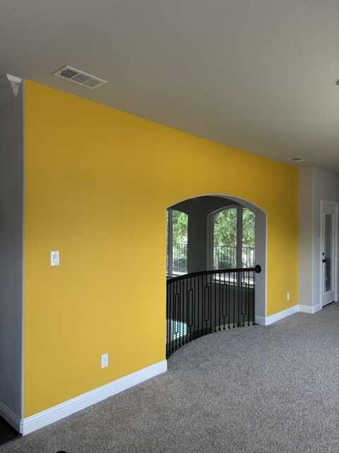 Finished bright yellow painted accent wall
