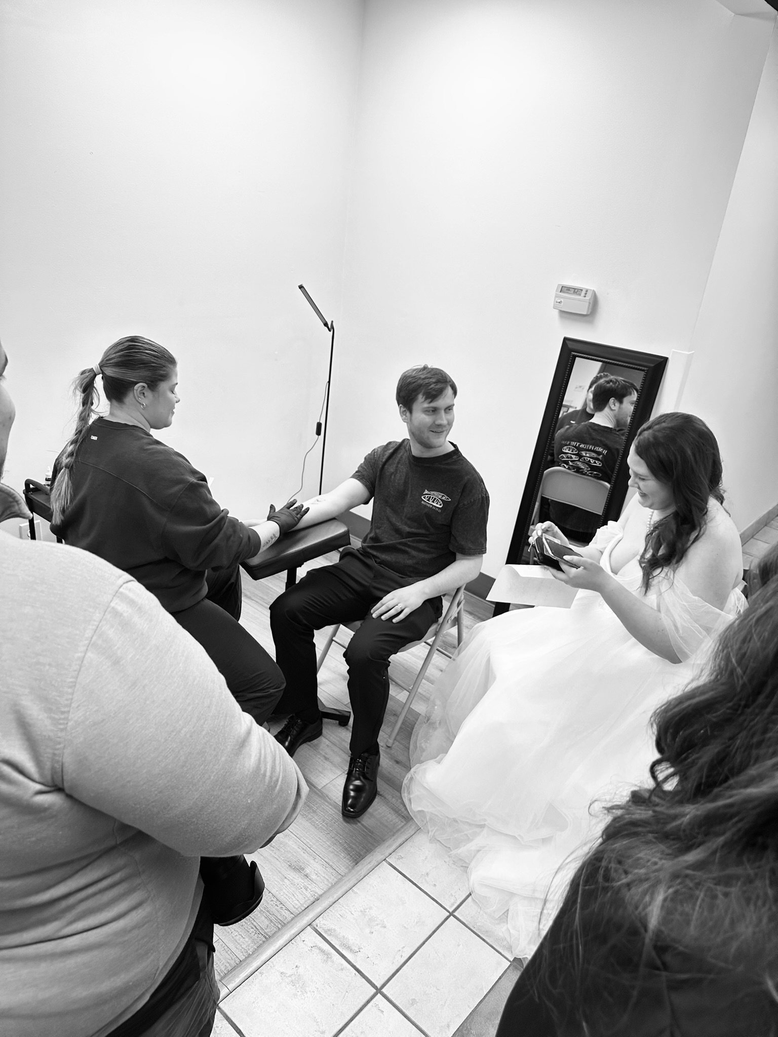 Wedding guests enjoying a live luxury fine line tattoo booth experience in Ohio